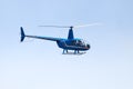 Undefined helicopter with passengers in blue sky