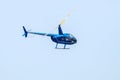 Undefined helicopter with passengers in blue sky