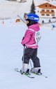 An undefined little skier before the start of the competition