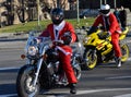 Undefined Santa delivering humanitarian aid in form of gifts to disabled children during annual Santa Claus Motorcycle Parade on