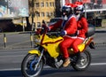 Undefined Santa delivering humanitarian aid in form of gifts to disabled children during annual Santa Claus Motorcycle Parade on