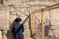 Undefined ultra-orthodox jewish person prays next to Western Wall in Jerusalem