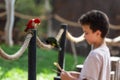 Undefined young boy feeding parrot at Israeli zoo