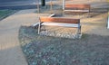 Under the bench are rectangles made of tiles. otherwise, the soft surface of the compacted gravel park path could erode the shoes