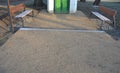 Under the bench are rectangles made of tiles. otherwise, the soft surface of the compacted gravel park path could erode the shoes