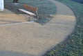 Under the bench are rectangles made of tiles. otherwise, the soft surface of the compacted gravel park path could erode the shoes