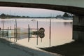 Under the Bridge near Boathouse: Calm Water At Sunset Royalty Free Stock Photo