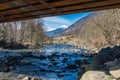 Italian mountain river called Noce River. View under the bridge. Snow covered mountains - Termenago, Val di Sole, Italy, Europe