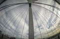 Under the Cable-stayed bridge tower, the image showing its long cable with cloudy sky in fish eyes angle lens.