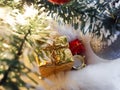 Under the Christmas tree on the faux fur is a gift in yellow packaging. Christmas and New Year. Royalty Free Stock Photo