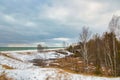 Under a cloudy Winter sky, a view of snow-covered dunes along Lake Michigan. Royalty Free Stock Photo