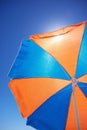 Under colourful beach umbrella