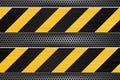 Under construction background. Black yellow stripes on metal perforated texture Royalty Free Stock Photo
