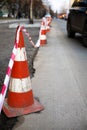 Under construction board sign on the closed road with arrow sign and traffic cone. Royalty Free Stock Photo