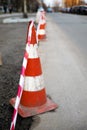 Under construction board sign on the closed road with arrow sign and traffic cone. Royalty Free Stock Photo