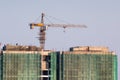 Under construction building with a crane on top and safety nets Royalty Free Stock Photo