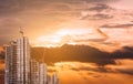 Under construction buildings with tower crane in sunset, developing city Royalty Free Stock Photo