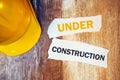 Under construction concept with protective yellow hard hat helmet