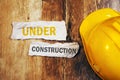 Under construction concept with protective yellow hard hat helme