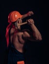 It is under construction. Hard worker use muscular strength. Construction worker hammer a nail. Muscular man builder at Royalty Free Stock Photo