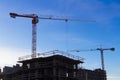 Under construction high-rise building with two cranes the background of blue sky Royalty Free Stock Photo
