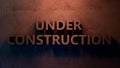 Under Construction sign 3d illustration. Concrete letters on the wall. Royalty Free Stock Photo
