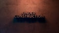 Under Construction sign 3d illustration. Concrete letters on the wall. Royalty Free Stock Photo