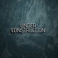 Under Construction sign 3d illustration. Letters on marble wall. Royalty Free Stock Photo