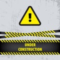 Under construction sign on gray ground background. Vector illustration for website. Under construction triangle with black and yel