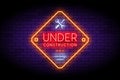 Under Construction sign in trendy neon style on the brick wall. Royalty Free Stock Photo