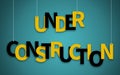 Under Construction text hanging on ropes