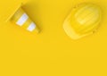 Under construction, traffic cones and safety helmet, isolated on bright yellow background in pastel colors Royalty Free Stock Photo