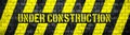 Under construction warning sign with yellow and black stripes on concrete brick wall texture background wide panorama format Royalty Free Stock Photo