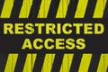 Restricted access text warning sign with yellow and black stripes painted over cracked wood Royalty Free Stock Photo