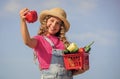 Is under control. kid on summer farm. Organic food. little girl vegetable in basket. Only natural. harvest vitamin