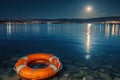 Under the moon\'s embrace: A lifebuoy gliding in a tranquil marina, basking in the moonlight\'s glow Royalty Free Stock Photo