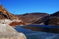 Under the nice blue sky covered with thin ice the Tsomgo Lake or Changu Lake water surrounded by stone hills Royalty Free Stock Photo