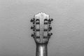 Under a nylon string guitar's headstock in black and white