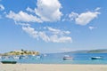 Under the perfect clouds, boats in a small fishing harbour at the beach in Sithonia