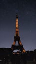 Under the starry canopy, the Eiffel Tower illuminated at night in Paris. Royalty Free Stock Photo