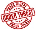 Under threat red grunge round stamp Royalty Free Stock Photo