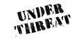 Under Threat rubber stamp Royalty Free Stock Photo