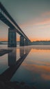 Under the twilight sky, the architectural symmetry of a modern bridge reflects on the water surface, creating a scene of Royalty Free Stock Photo