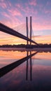 Under the twilight sky, the architectural symmetry of a modern bridge reflects on the water surface, creating a scene of Royalty Free Stock Photo