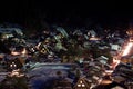 Under the veil of night, the winter-enshrouded Shirakawa village illuminates with the soft glow of lighted houses