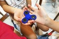 Underaged kids playing the fidget spinner. Maybe hazardous to kids.