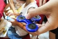 Underaged kids playing the fidget spinner. Maybe hazardous to kids.