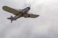 The underbelly view of the tail, body, wings, nose and propeller of Piper PA-25 Pawnee tow aircraft in the air