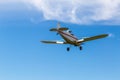 The underbelly view of the tail, body, wings, nose and propeller of Piper PA-25 Pawnee tow aircraft in the air Royalty Free Stock Photo