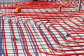 Underfloor heating system with red pipes on construction site Royalty Free Stock Photo